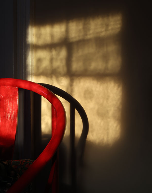 Photo with Strong Light and Shadows on Wallpaper and Furniture.